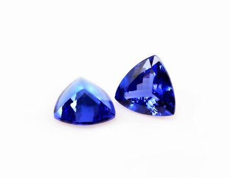 Pair of trillant shape tanzanite gemstones, isolated over white.の写真素材