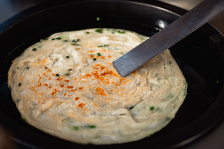 Omelette with herbs in a frying pan, close-upの写真素材