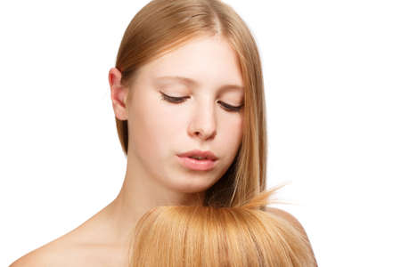 Young beautiful woman with long blond hair isolated on white backgroundの写真素材