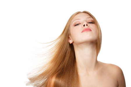 Young beautiful woman with long blond hair flying isolated on white backgroundの写真素材