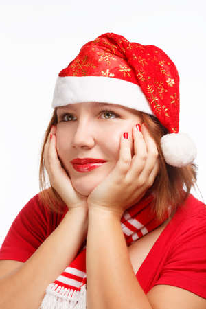 Young woman in new year or christmas suit smiling in thoughtful pose isolated on white backgroundの写真素材
