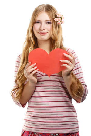 Beautiful young smiling woman in pink striped blouse with red paper valentine heart in hands isolated on white backgroundの写真素材