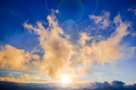Beautiful scenic landscape with dramatic clouds and sunbeams of the setting sun in the sky.の写真素材