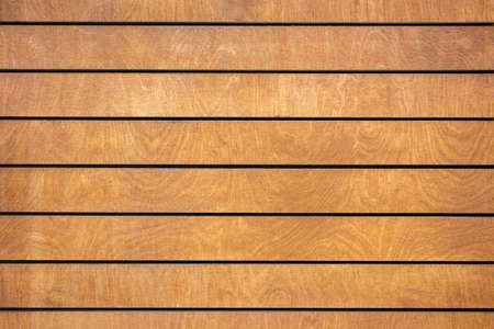 Abstract brown striped wall background of rectangular horizontal, wooden panels with spots and stains of wood structure, Copyspace.の写真素材