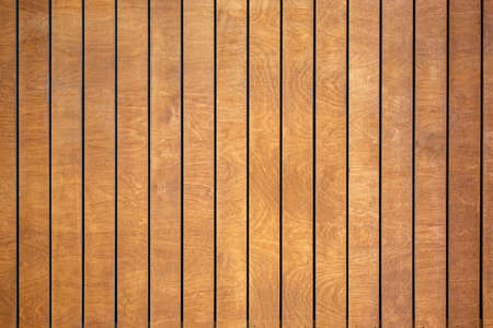 Abstract brown striped wall background of rectangular vertical wooden panels with spots and stains of wood structure, Copyspace.の写真素材