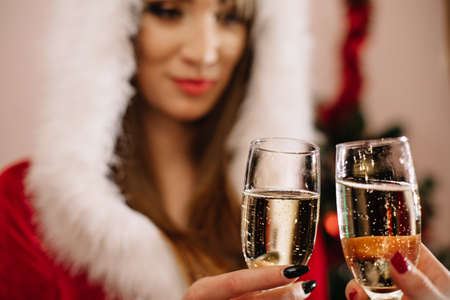 Happy Snow Maiden with glass of champagne isolated on whiteの写真素材