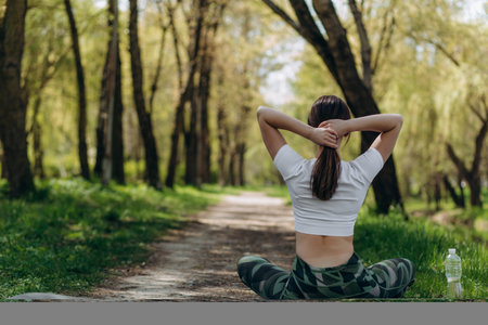 Beautiful plus size girl doing yoga in nature on a sunny summer day. Body positive, sports for...