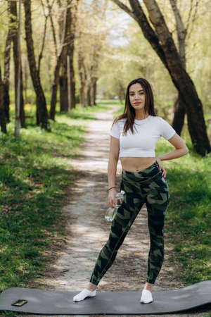 beautiful girl training. Sports girl in a sportswear. Brunette holding proteine in her handsの写真素材