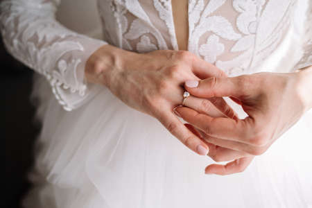 Gold wedding rings are on the bride's handの写真素材