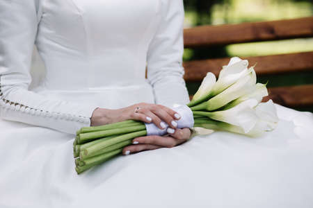 Bride holding big wedding bouquet on wedding ceremonyの写真素材