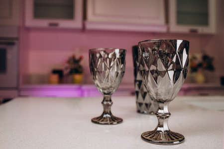 Empty Glasses and Wine Carafe in Stylish Modern Kitchenの写真素材