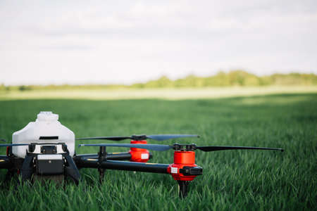 Agriculture drone flying on the green tea field at sunriseの写真素材