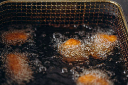 Close up image of cooking chicken nugget tempura in deep fryの写真素材