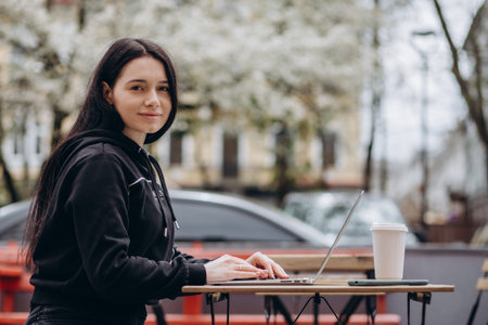 beautiful young woman using technology outdoors