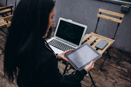 Close up of woman using blank laptop order products for shopping online within the cafe.の写真素材