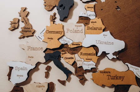 selective focus. Wooden world map on thr wall. Geography concept. background for travel. Logistics and transportation, worldwide business. Europe close upの写真素材