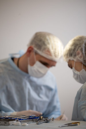 Team of surgeon in uniform perform operation on a patient at plastic surgery clinic