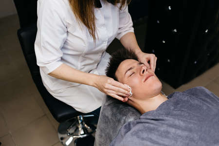 Man having face massage in spa salonの写真素材