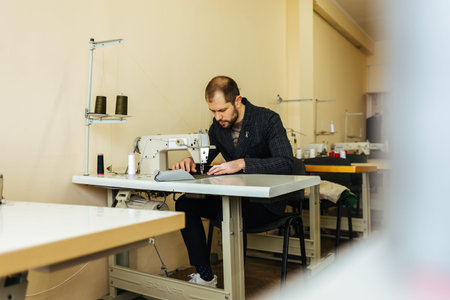 Young man tailor working on new clothesの写真素材