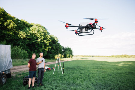 Modern drone flying over wheat grain field on sunny day. agriculture industry