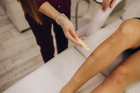 Applying a contact gel before the procedure of laser hair removal. Application of sugar paste for the procedure of shugaring.の写真素材