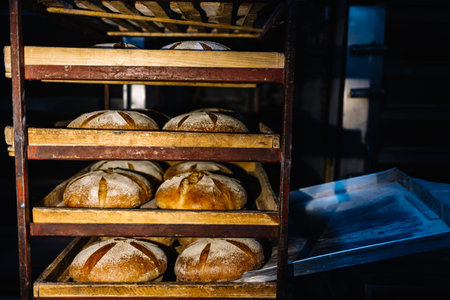 Dessert bread baking in the oven. Production oven at the bakery. Baking bread. Manufacture of bread.