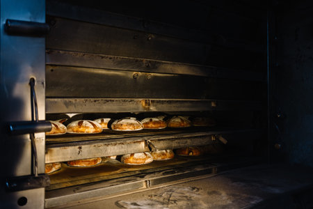 Dessert bread baking in the oven. Production oven at the bakery. Baking bread. Manufacture of bread.の写真素材