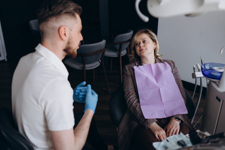 Doctor dentist showing patient's teeth on X-rayの写真素材