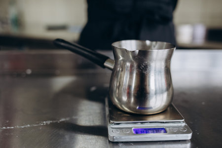 Woman measuring temperature of melted wax in kitchen, closeup. Making homemade candles.