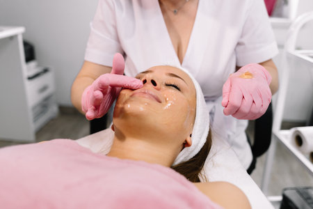 young beautiful woman with facial mask, spa treatmentの写真素材