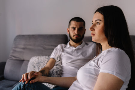 Couple dreaming to be parents. Upset man comforting his depressed wife with negative pregnancy test,...