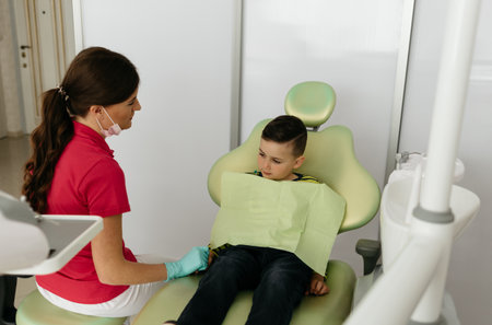 Cute little boy and dentist in clinicの写真素材