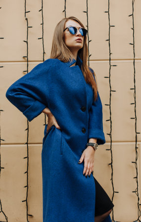 Young fashionable woman wearing blue coatの写真素材