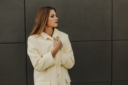 A portrait of a thoughtful beautiful girl wearing a white fur coat. Beauty, winter fashion.の写真素材