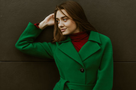 Beautiful fashion model in autumn green clothes on background. Sexy lady in elegant coat.の写真素材