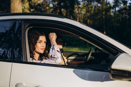 the happy couple man and woman in car traveling in summerの写真素材