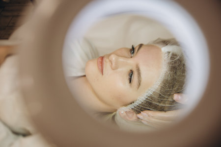 Woman undergoing procedure of vacuum hydro peeling in beauty salonの写真素材