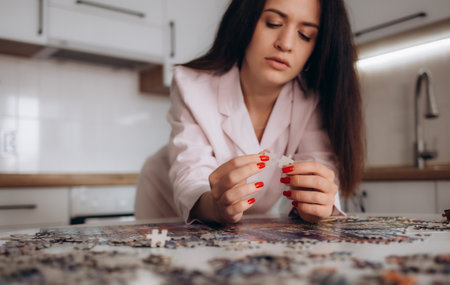 Close up of young woman doing puzzleの写真素材