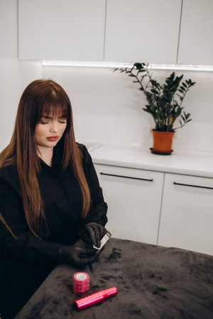 permanent master with tattoo machine in handの写真素材