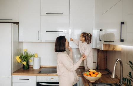 Mother and daughter having a healthy breakfast in the kitchenの写真素材