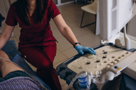 Medical specialist performing doppler ultrasound of the lower limb vesselsの写真素材