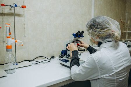 Scientist researcher using microscope in laboratory. Medical healthcare technology and pharmaceutical research and development concept.の写真素材