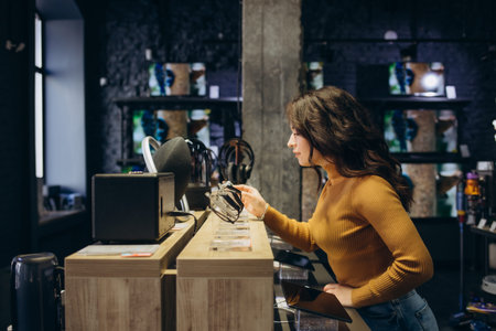 Portrait of happy smiling woman shopping a new smart watch in tech store. technology people concept.の写真素材