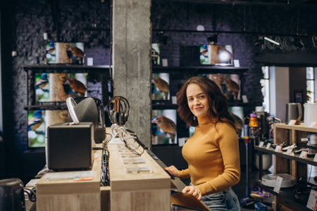 Portrait of happy smiling woman shopping a new smart watch in tech store. technology people concept.の写真素材
