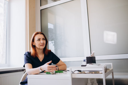 Portrait of senior female doctor on hospital corridor looking at camera smiling.の写真素材