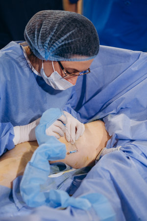 doctor and an assistant in the operating room for surgical venous vascular surgery clinic.の写真素材
