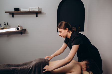 View of a Young attractive masseuse doing a capillary massageの写真素材