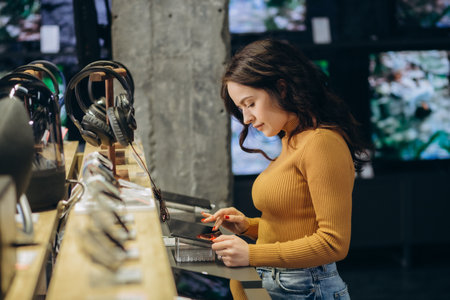 woman in an tech store chooses a tablet.の写真素材