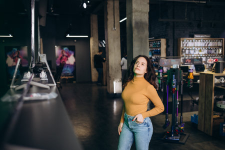 a beautiful woman in tech store chooses a TV.