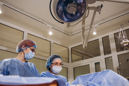 doctor and an assistant in the operating room for surgical venous vascular surgery clinic.の写真素材